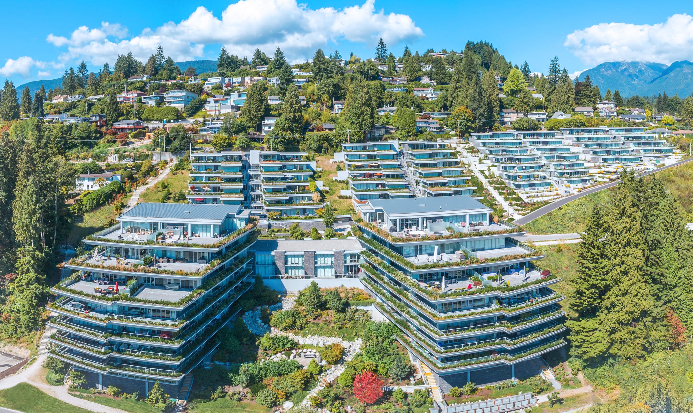 Aerial of the Evelyn community terraced on Sentinel Hill, West Vancouver, with the North Shore mountains beyond