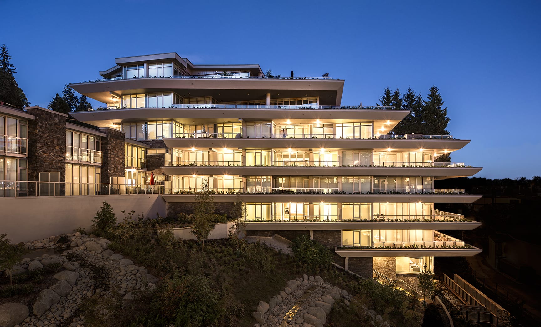 Forest Edge homes at Evelyn illuminated at dusk, West Vancouver