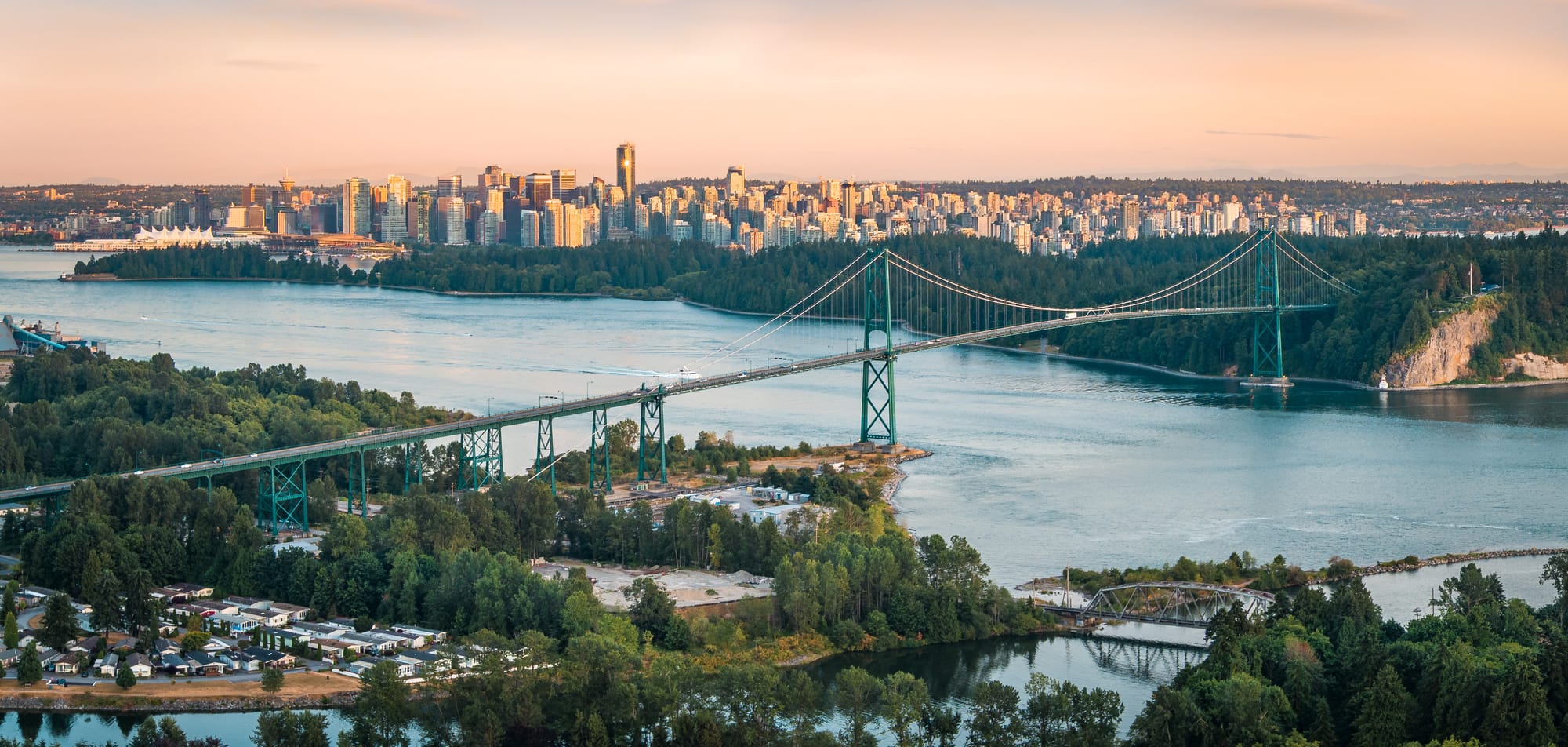 Lions Gate Bridge and the downtown Vancouver skyline seen from West Vancouver at dusk